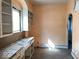 Outdated kitchen featuring wood floors, open white shelving, and a double sink at 2148 Singleton St, Indianapolis, IN 46203