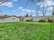 Expansive backyard with lush lawn, detached garage, and a charming single-story home at 25249 State Road 13 N, Noblesville, IN 46060