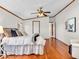 Well-lit bedroom with hardwood floors, ample space, and an airy feel with a peek at the en suite bath at 25249 State Road 13 N, Noblesville, IN 46060