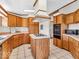 Functional kitchen featuring laminate floors, island cooktop, and modern appliances at 25249 State Road 13 N, Noblesville, IN 46060