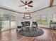 Spacious living room with a fireplace, natural light, a ceiling fan and sliding glass door to the exterior at 25249 State Road 13 N, Noblesville, IN 46060