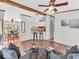 Open living area with modern furniture, ceiling fan, and adjacent dining and kitchen areas at 25249 State Road 13 N, Noblesville, IN 46060