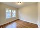 Comfortable bedroom with hardwood floors, natural light from a window, and a closet door creating a serene atmosphere at 2528 E 17Th St, Indianapolis, IN 46218