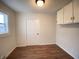 Simple bedroom featuring hardwood-look floors, a built in cabinet, and a window, a perfect space for relaxation at 2528 E 17Th St, Indianapolis, IN 46218