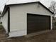 Exterior of the garage with a new brown garage door and white vinyl siding at 2528 E 17Th St, Indianapolis, IN 46218