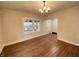 Inviting living room showcases original hardwood floors, new windows and a modern light fixture, for comfortable living at 2528 E 17Th St, Indianapolis, IN 46218