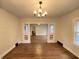 An open living space showcasing hardwood floors, decorative pillars, and a modern chandelier, offering a warm welcome at 2528 E 17Th St, Indianapolis, IN 46218