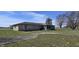 Property featuring a screened-in patio and spacious backyard, ideal for entertaining and recreation at 3002 W 53Rd St, Anderson, IN 46011