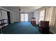Bedroom featuring green carpet, a ceiling fan, sliding glass doors, and natural light at 3002 W 53Rd St, Anderson, IN 46011