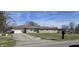 Charming single-story home with a concrete driveway leading to an attached garage at 3002 W 53Rd St, Anderson, IN 46011