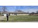 Ranch home with a stone facade, attached garage, and well-maintained front lawn at 3002 W 53Rd St, Anderson, IN 46011