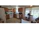 Kitchen featuring wooden cabinets, white appliances, and a dining area at 3002 W 53Rd St, Anderson, IN 46011