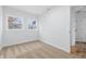 Bright bedroom featuring neutral carpet, white walls, and two windows providing natural light at 3105 N Tacoma Ave, Indianapolis, IN 46218