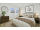 Relaxing bedroom with neutral tones, hardwood floors, and natural light from the window at 3105 N Tacoma Ave, Indianapolis, IN 46218