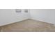 Neutral carpeted bedroom with two windows, and white painted trim at 3105 N Tacoma Ave, Indianapolis, IN 46218