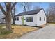Quaint, updated home featuring white siding, a new roof, black trim and a bright green front door at 3105 N Tacoma Ave, Indianapolis, IN 46218