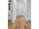 Bright hallway featuring wood-look floors, white trim, and paneled doors for a modern, inviting feel at 3105 N Tacoma Ave, Indianapolis, IN 46218