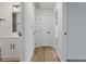 Bright hallway featuring wood-look floors, white trim, and paneled doors for a modern, inviting feel at 3105 N Tacoma Ave, Indianapolis, IN 46218