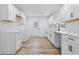 Modern kitchen featuring new white cabinets, white quartz countertops, stainless faucet and new wood flooring at 3105 N Tacoma Ave, Indianapolis, IN 46218