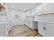 Modern kitchen featuring new white cabinets, white quartz countertops, stainless faucet and new wood flooring at 3105 N Tacoma Ave, Indianapolis, IN 46218