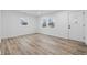 Bright living room featuring modern wood flooring, fresh white paint, new trim, and lots of natural light at 3105 N Tacoma Ave, Indianapolis, IN 46218