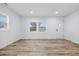 Bright living room featuring modern wood flooring, fresh white paint, new trim, and lots of natural light at 3105 N Tacoma Ave, Indianapolis, IN 46218