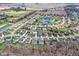 Aerial view of a suburban neighborhood featuring a central pond, manicured lawns, and a peaceful, Gathering-friendly environment at 320 Legacy Blvd, Greenwood, IN 46143