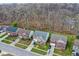Aerial view of a neighborhood showcasing well-maintained homes with manicured lawns, driveways, and tree-lined streets at 320 Legacy Blvd, Greenwood, IN 46143