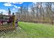 A backyard featuring a wooden deck with outdoor furniture and a lush lawn bordered by a chain-link fence at 320 Legacy Blvd, Greenwood, IN 46143