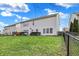 A well-maintained lawn, a fenced yard, and a deck with a hot tub in a spacious backyard at 320 Legacy Blvd, Greenwood, IN 46143