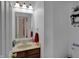 Clean bathroom featuring a mirror, vanity, and a view into an adjacent room at 320 Legacy Blvd, Greenwood, IN 46143