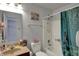 Bathroom featuring a shower-tub combo with blue curtain, sink, and mirror at 320 Legacy Blvd, Greenwood, IN 46143
