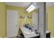 A simple bathroom featuring white cabinets, white walls, and good lighting above the sink at 320 Legacy Blvd, Greenwood, IN 46143