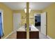 Bathroom featuring double sinks, good lighting, white flooring, and yellow walls at 320 Legacy Blvd, Greenwood, IN 46143