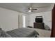 Spacious bedroom featuring neutral carpet, ceiling fan, dresser, and closet access at 320 Legacy Blvd, Greenwood, IN 46143