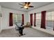 Carpeted bedroom with a ceiling fan, large windows, and great natural light at 320 Legacy Blvd, Greenwood, IN 46143