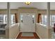 Bright and inviting foyer with a white front door, wood floors, and neutral walls at 320 Legacy Blvd, Greenwood, IN 46143