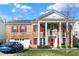 Charming two-story brick home with red shutters, grand white columns, and a well-manicured lawn at 320 Legacy Blvd, Greenwood, IN 46143