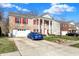 Charming two-story brick home with red shutters, grand white columns, and a well-maintained driveway at 320 Legacy Blvd, Greenwood, IN 46143