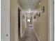 Neutral hallway with warm lighting offers a view to multiple rooms and storage space at 320 Legacy Blvd, Greenwood, IN 46143