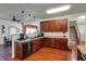 Spacious kitchen featuring rich wood cabinets, updated appliances and wood-look floors at 320 Legacy Blvd, Greenwood, IN 46143