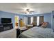 A spacious main bedroom with a carpet, ceiling fan and a seating area next to the windows at 320 Legacy Blvd, Greenwood, IN 46143