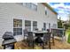 A well-furnished patio with a grill, dining set, and hot tub, perfect for outdoor entertainment at 320 Legacy Blvd, Greenwood, IN 46143
