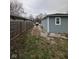 Exterior shot of the back yard with gravel driveway and wooden fence at , Indianapolis, IN 46221