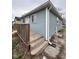 Exterior view showing light blue siding, white trim, and wooden porch steps at , Indianapolis, IN 46221