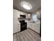 Modern kitchen with white cabinets, new appliances, and stylish backsplash at , Indianapolis, IN 46221