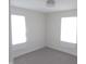 Bright bedroom with carpet flooring and two windows providing natural light at 3323 E 36Th St, Indianapolis, IN 46218