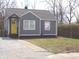 Charming home featuring a yellow door and gray siding and a well maintained landscape at 3323 E 36Th St, Indianapolis, IN 46218
