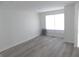 Spacious living room featuring new gray laminate flooring and a light-filled window at 3323 E 36Th St, Indianapolis, IN 46218