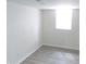 Bright room featuring new gray laminate flooring and a light-filled window at 3323 E 36Th St, Indianapolis, IN 46218